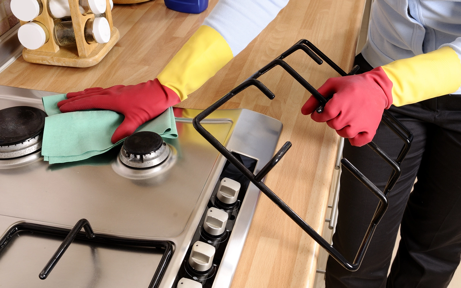 Vail Valley Home Watch trusted housekeeping partner cleaning a kitchen stovetop in a Colorado second home