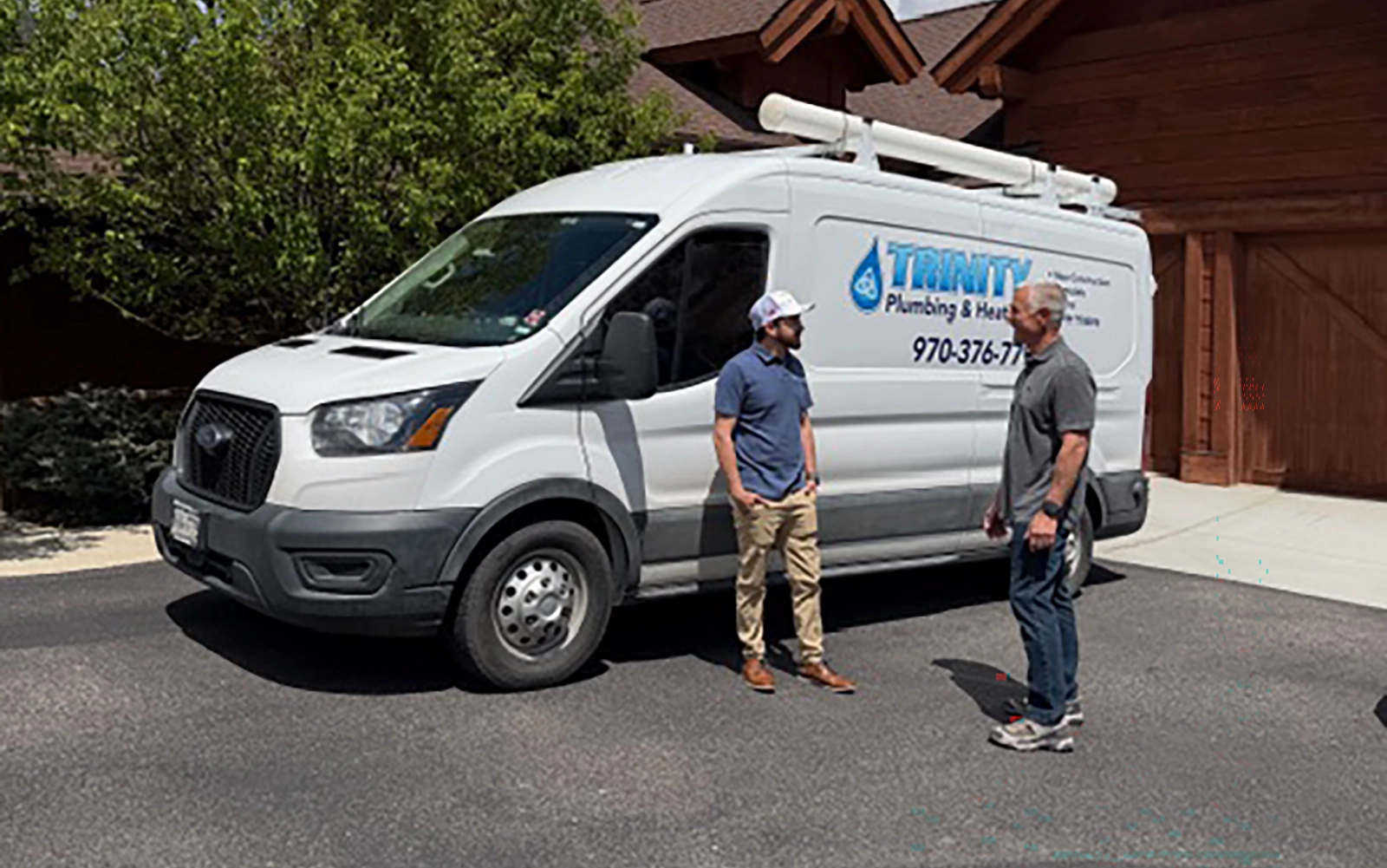 Mark Fleecs of Vail Valley Home Watch coordinating with a Trinity Plumbing & Heating vendor at a client's mountain home